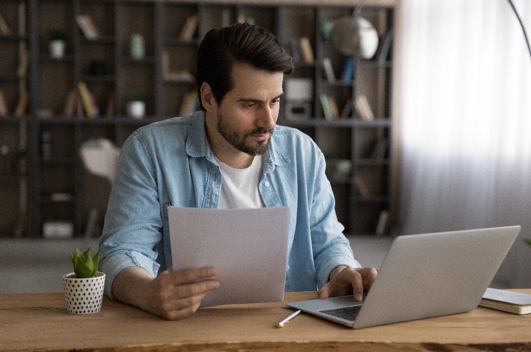 Focused businessman using laptop, looking at screen, serious man working with financial documents or correspondence, checking data, analyzing statistics, student busy with research project