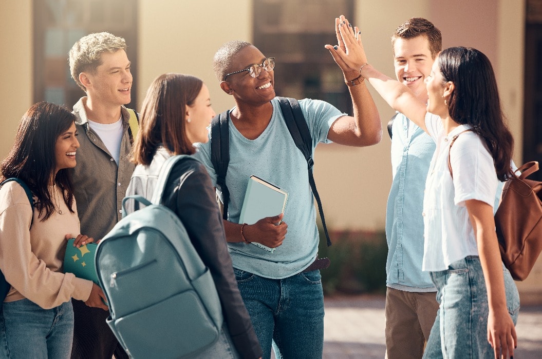 University, friends and student high five of diversity, college and education group outdoor. Students, study and success support hand gesture of people with happiness excited about learning goal